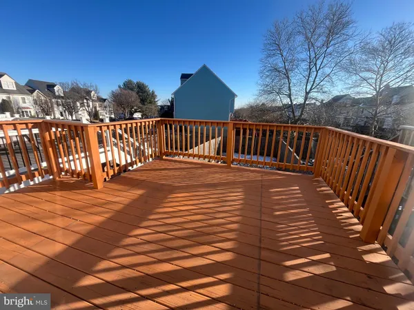 a view of balcony with wooden floor and fence
