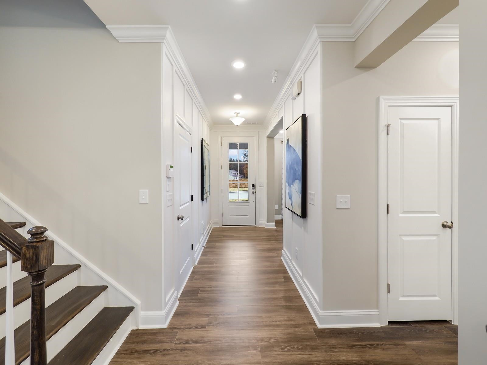 1100 Red Roses Avenue Durham, NC 27703 - Photo 19 of 51 a view of a hallway with wooden floor and staircase
