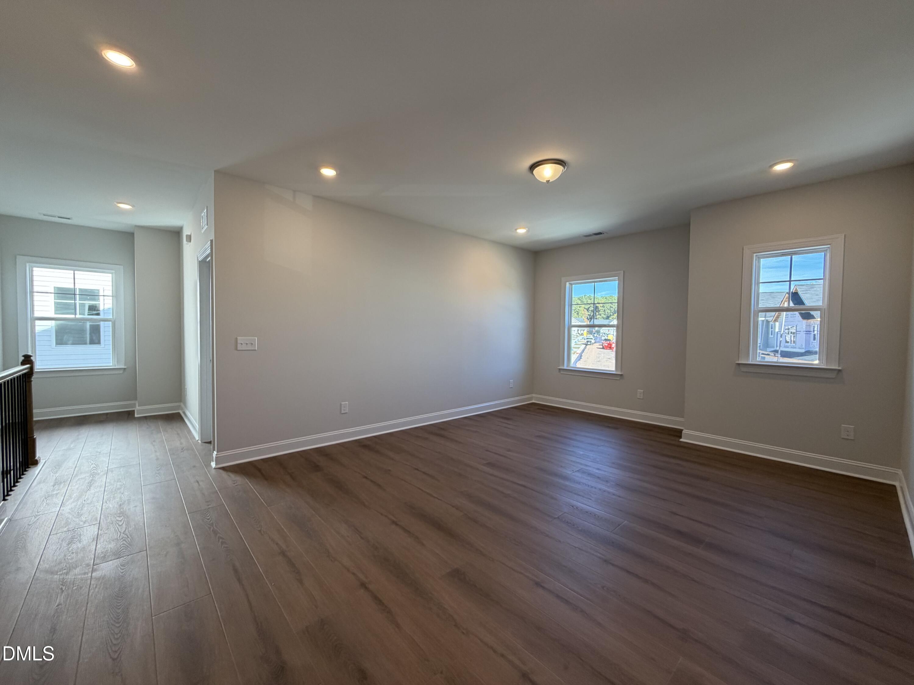 1100 Red Roses Avenue Durham, NC 27703 - Photo 8 of 51 an empty room with wooden floor and windows