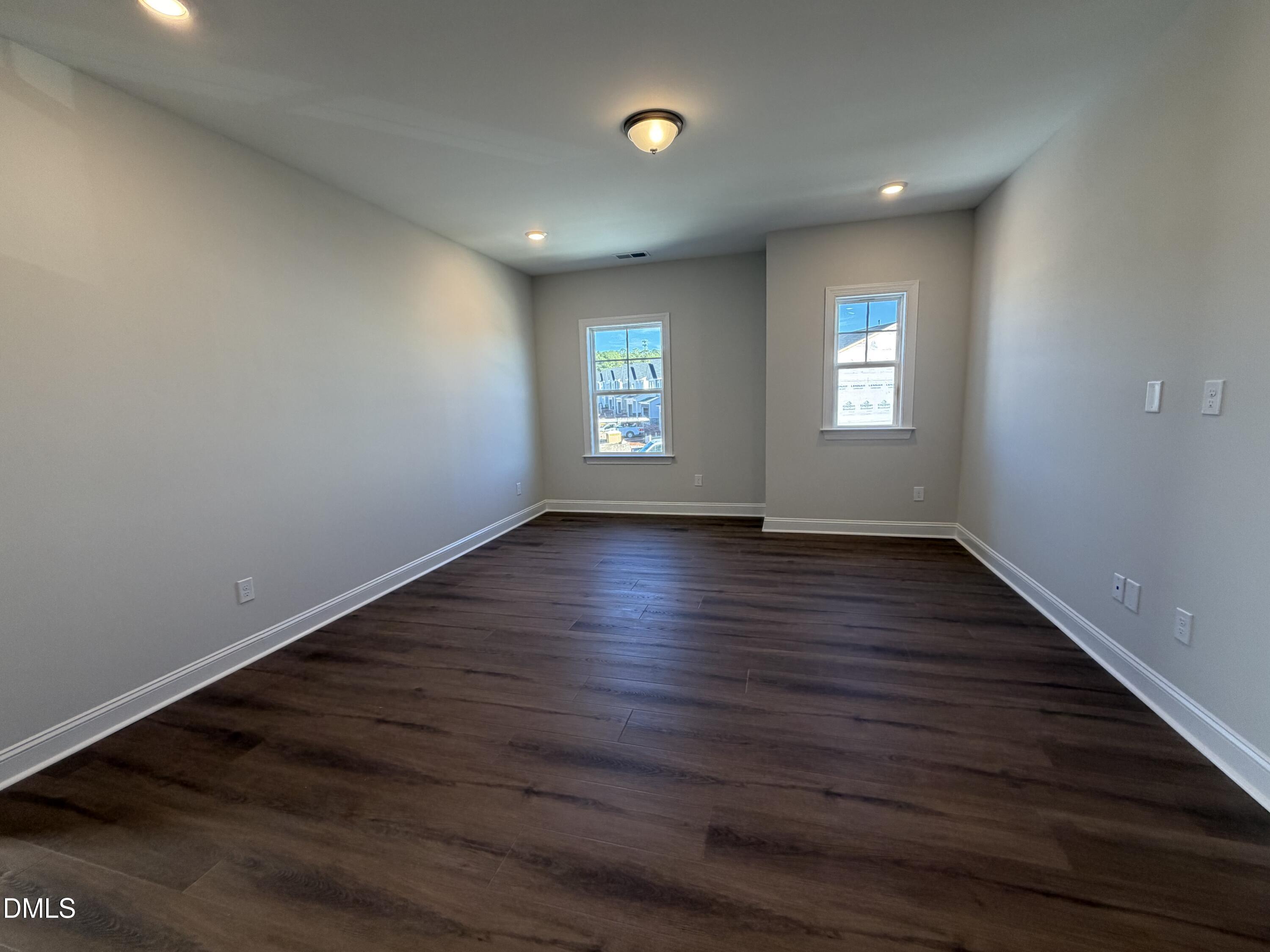 1100 Red Roses Avenue Durham, NC 27703 - Photo 9 of 51 an empty room with wooden floor and windows