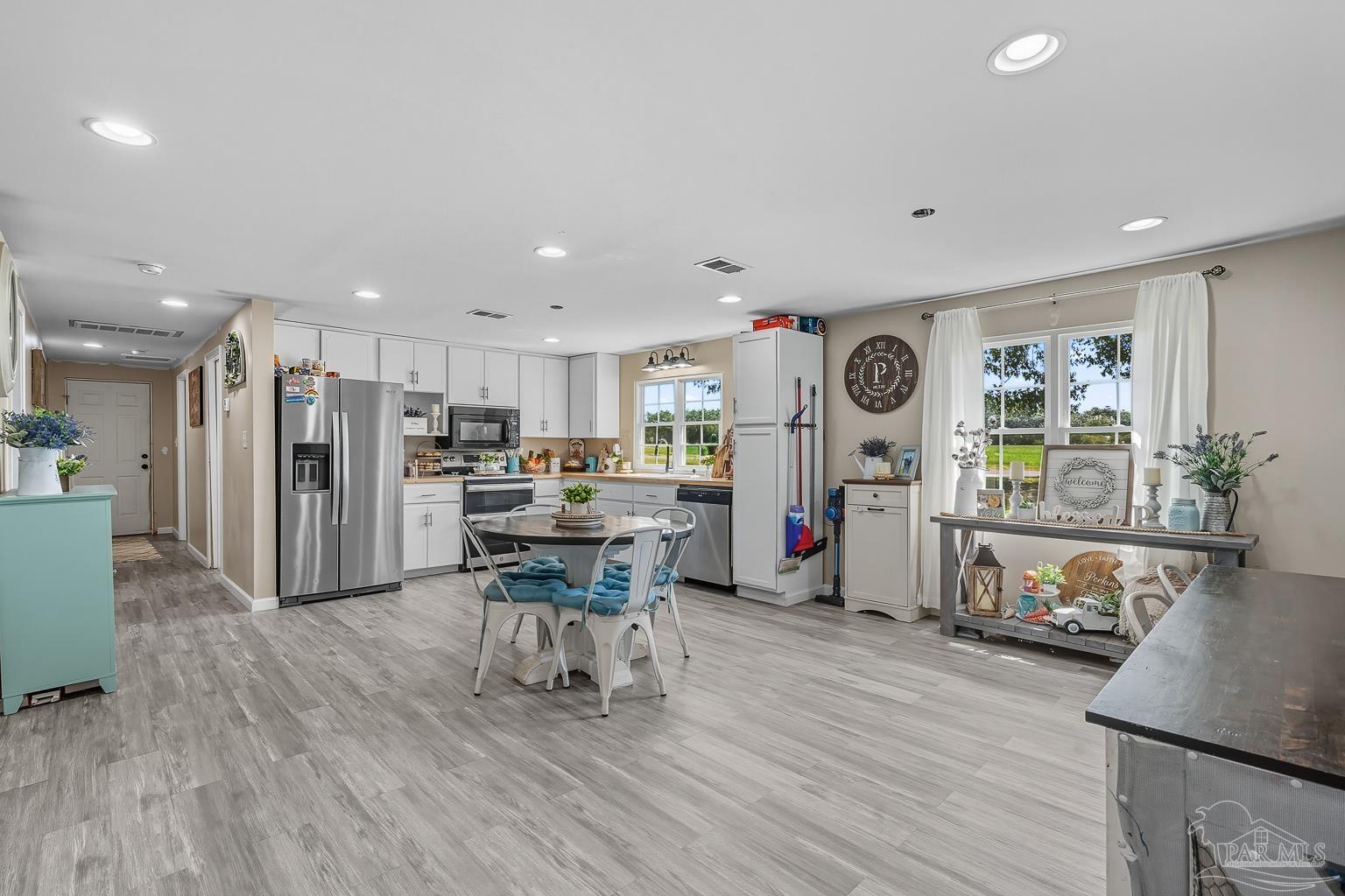 2436 Renfroe Road Pace, FL 32571 - Photo 11 of 45 a living room with lots of furniture and kitchen view