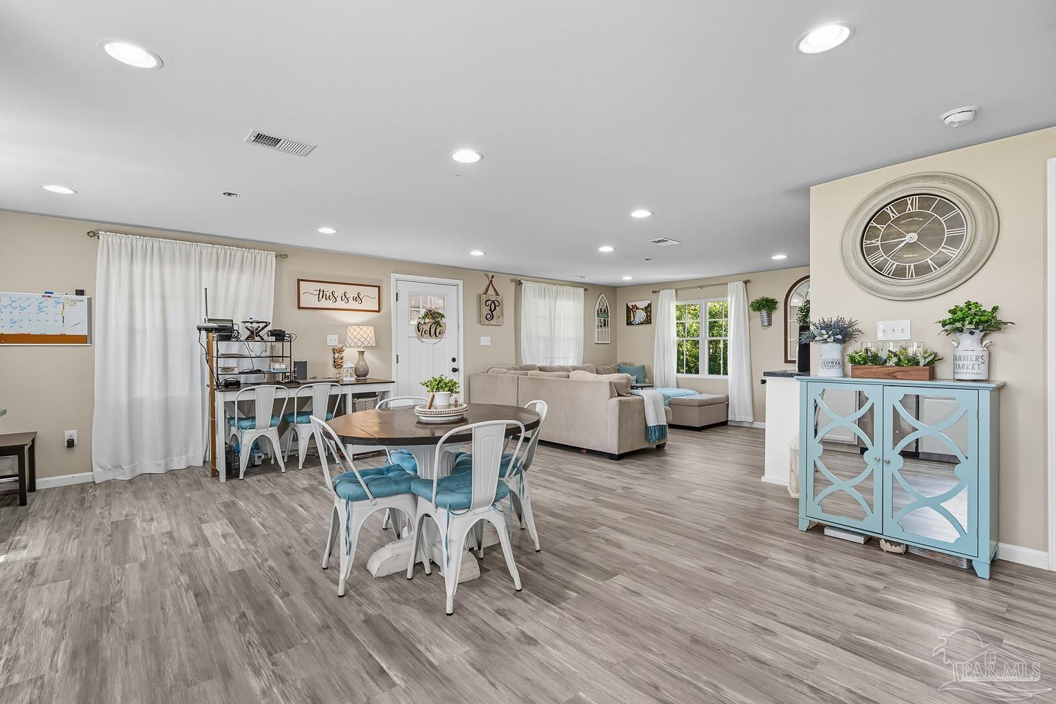 2436 Renfroe Road Pace, FL 32571 - Photo 18 of 45 a living room with furniture a clock and a table
