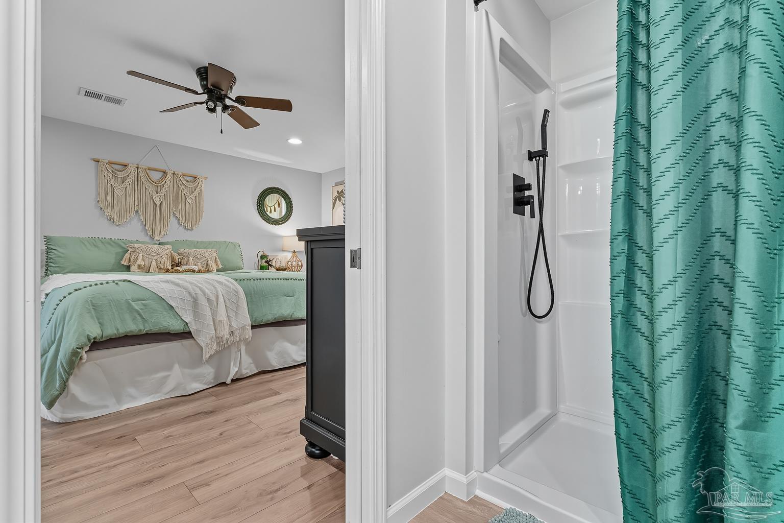 2436 Renfroe Road Pace, FL 32571 - Photo 27 of 45 a bedroom with a bed and a chandelier