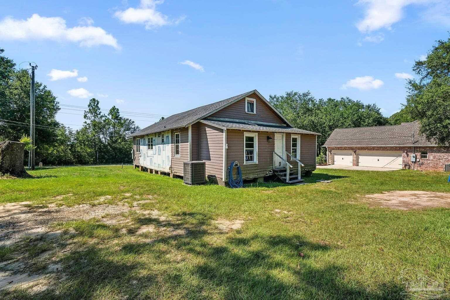 2436 Renfroe Road Pace, FL 32571 - Photo 34 of 45 a view of a house with backyard and garden