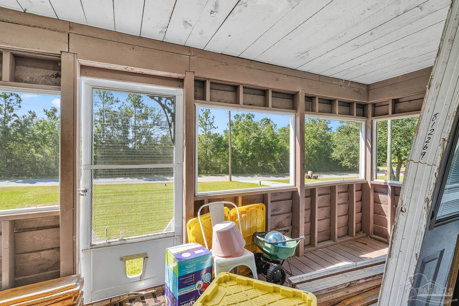 2436 Renfroe Road Pace, FL 32571 - Photo 42 of 45 a view of a patio with a table chairs and balcony