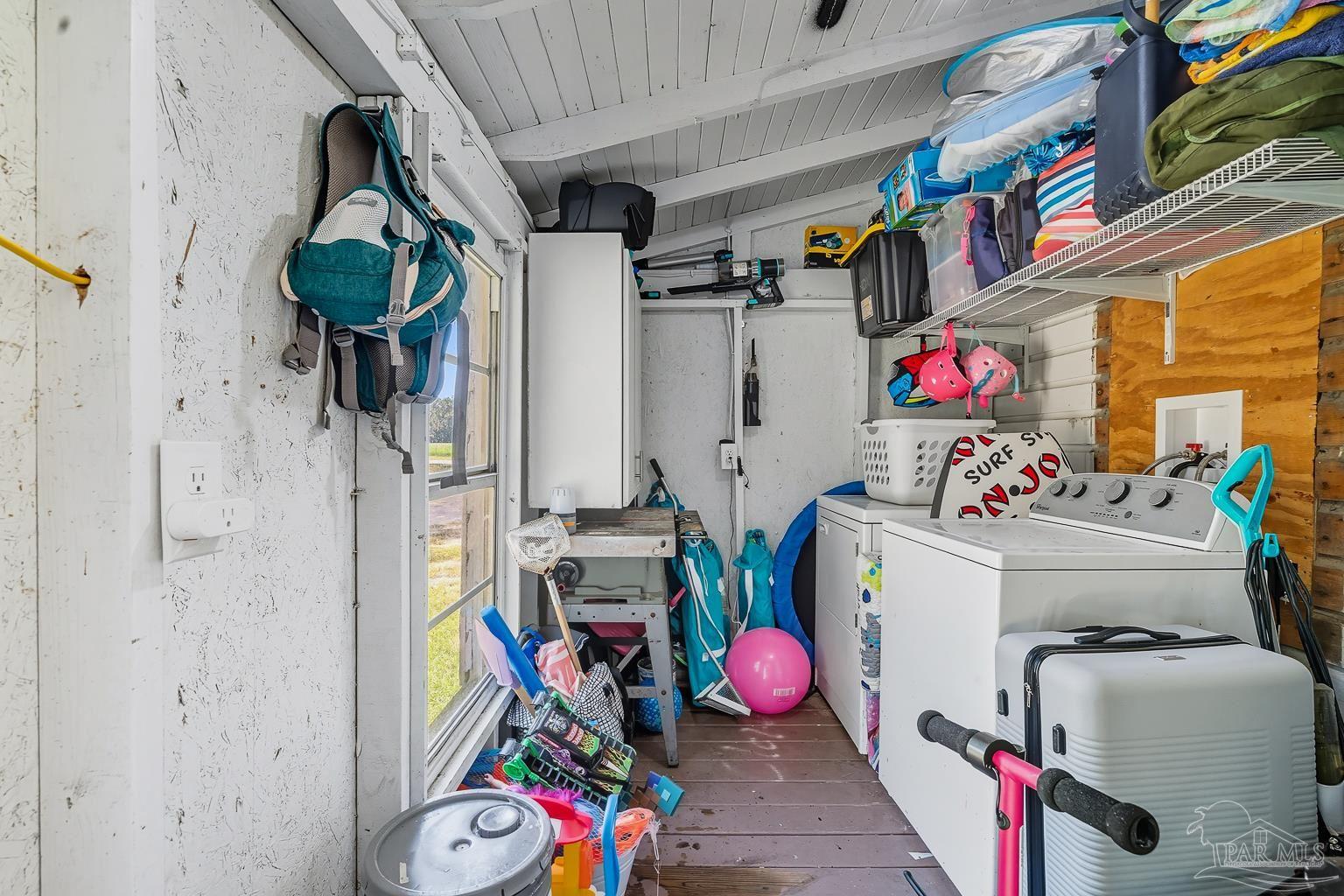 2436 Renfroe Road Pace, FL 32571 - Photo 44 of 45 a view of storage and utility room with fridge and closet
