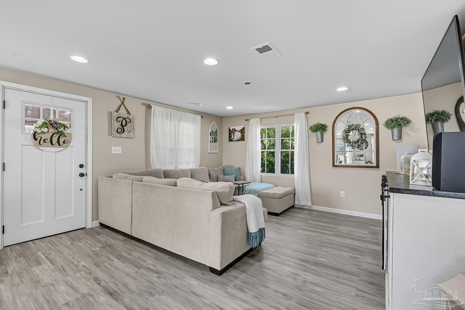 2436 Renfroe Road Pace, FL 32571 - Photo 5 of 45 a living room with furniture and wooden floor