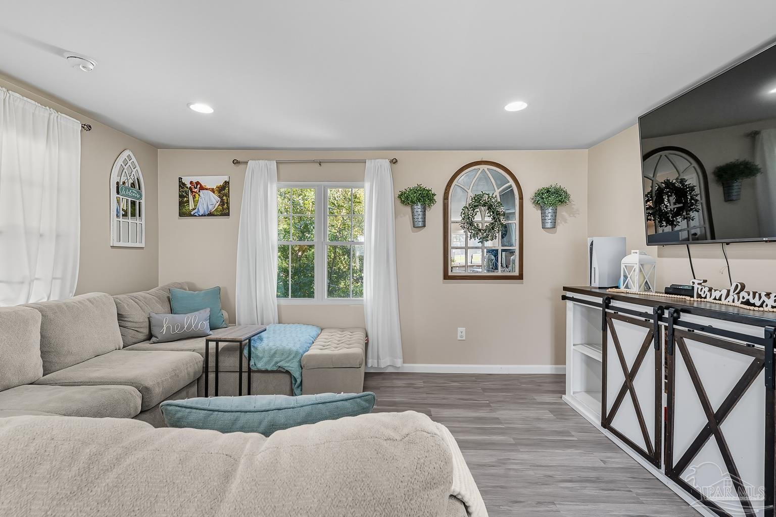 2436 Renfroe Road Pace, FL 32571 - Photo 6 of 45 a living room with furniture a window and a flat screen tv