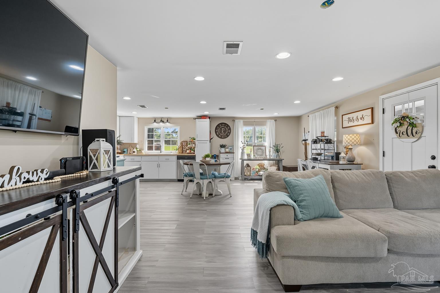 2436 Renfroe Road Pace, FL 32571 - Photo 8 of 45 a living room with furniture and wooden floor