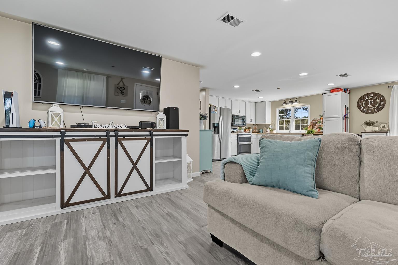 2436 Renfroe Road Pace, FL 32571 - Photo 9 of 45 a living room with furniture and kitchen view