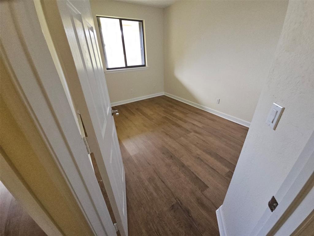 6185 Laurel Lane, Unit B Tamarac, FL 33319 - Photo 12 of 12 a view of an empty room and wooden floor