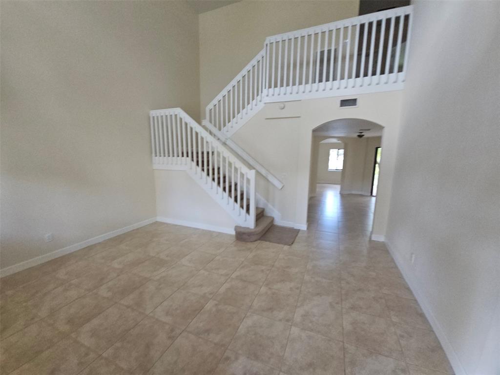 6185 Laurel Lane, Unit B Tamarac, FL 33319 - Photo 3 of 12 a view of staircase with white walls and stairs