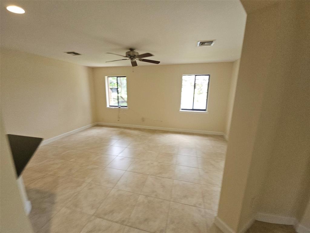 6185 Laurel Lane, Unit B Tamarac, FL 33319 - Photo 5 of 12 a view of empty room with windows