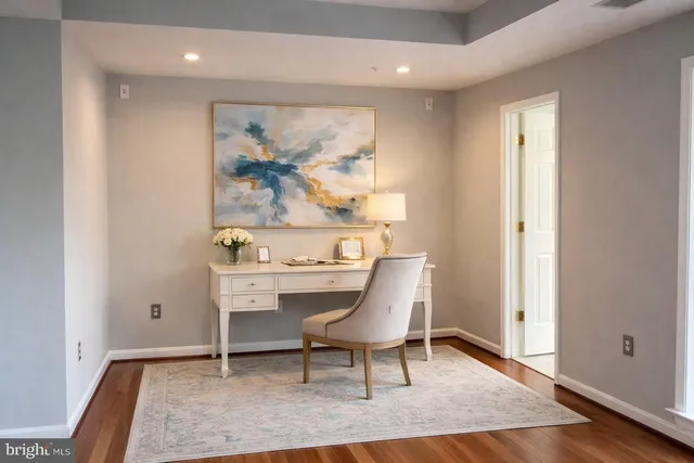 a bathroom with a tub a sink and a large mirror