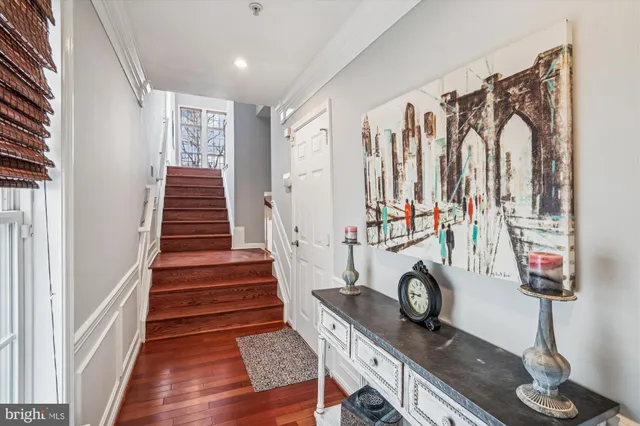 a view of entryway and hall with wooden floor