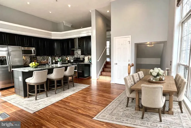 a dining room with furniture a rug and wooden floor