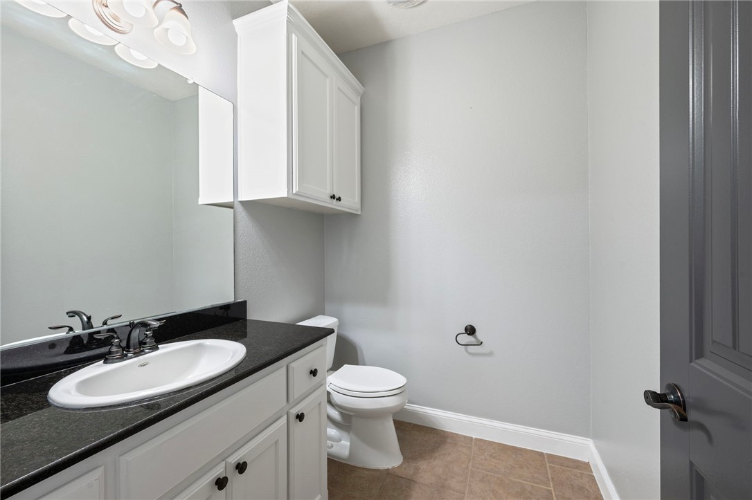 3304 Keefer Loop College Station, TX 77845 - Photo 17 of 21 a bathroom with a granite countertop sink toilet and a mirror