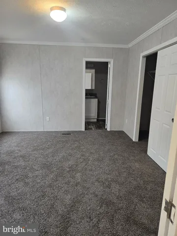 a view of an empty room and closet area