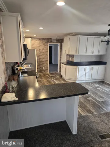 a view of a living room and kitchen