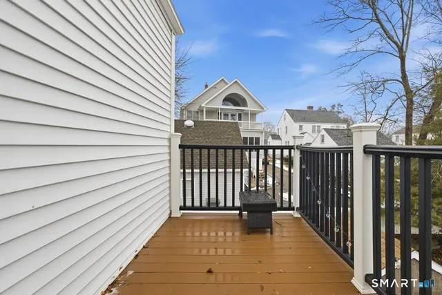 a view of a brick house with wooden fence