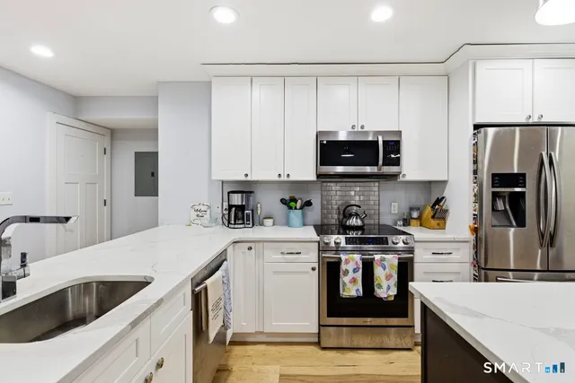 a kitchen with a sink stove and refrigerator