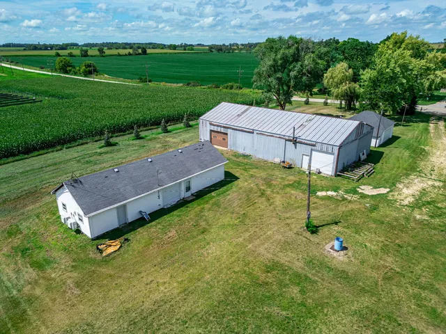 an aerial view of a house with garden space and street view