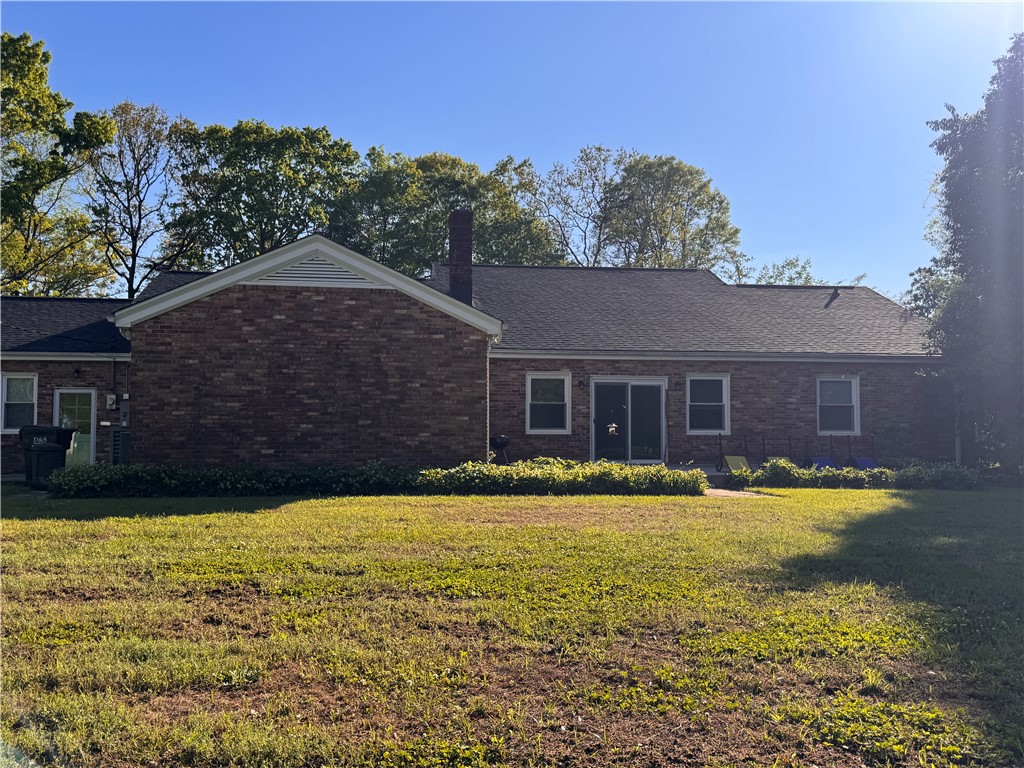 2211 East River Street Anderson, SC 29621 - Photo 3 of 40 This house features a classic brick exterior and a well-maintained yard.