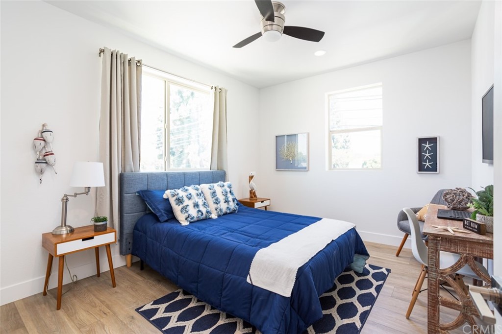 6514 Alondra Boulevard Paramount, CA 90723 - Photo 4 of 10 a bedroom with a bed and wooden floor