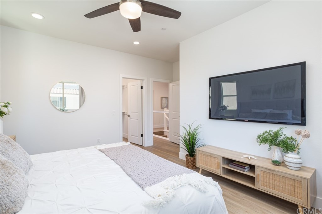 6514 Alondra Boulevard Paramount, CA 90723 - Photo 6 of 10 a bedroom with a bed potted plant and a chandelier