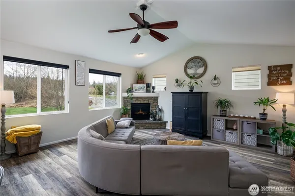 a living room with furniture a fireplace and a large window