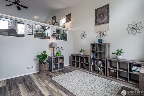 a living room with furniture and a bookshelf