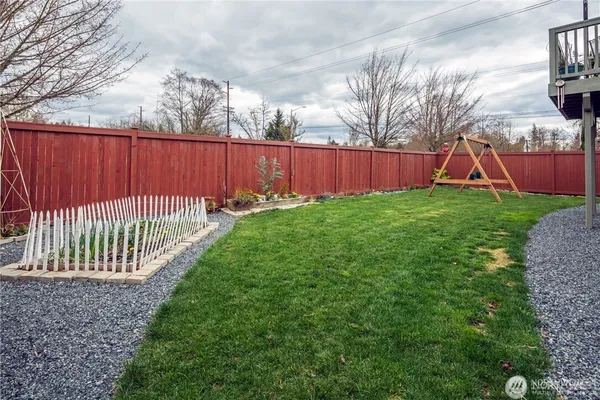 a view of a backyard with wooden fence