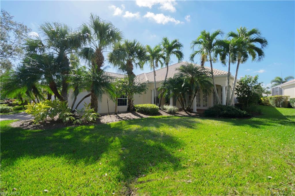 5120 Inagua Way Naples, FL 34119 - Photo 1 of 35 a view of a house with a yard and palm trees