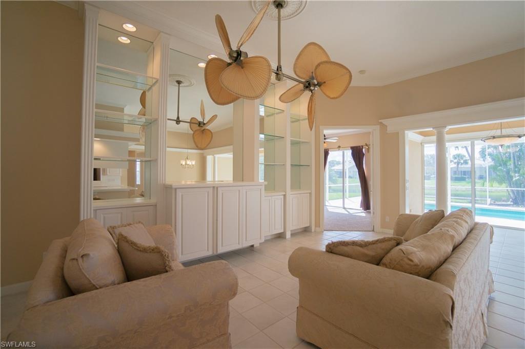 5120 Inagua Way Naples, FL 34119 - Photo 12 of 35 a living room with furniture a chandelier and a large window