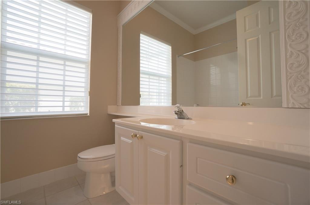 5120 Inagua Way Naples, FL 34119 - Photo 18 of 35 a bathroom with a sink a toilet and a window