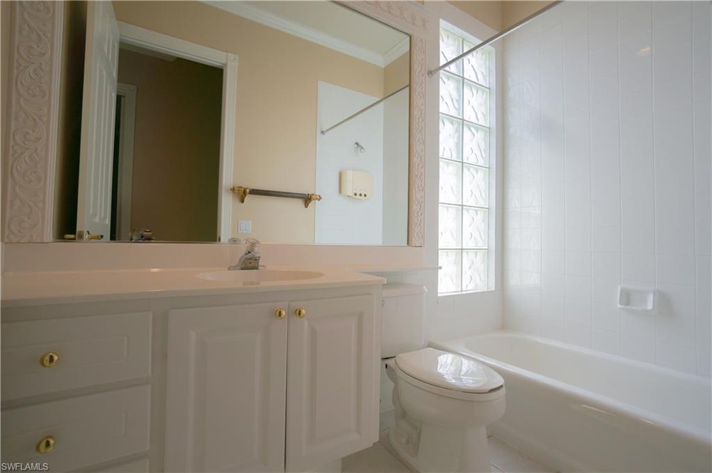 5120 Inagua Way Naples, FL 34119 - Photo 20 of 35 a bathroom with a toilet a sink a tub and mirror