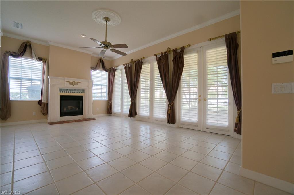 5120 Inagua Way Naples, FL 34119 - Photo 3 of 35 a view of an empty room with a fireplace and a window