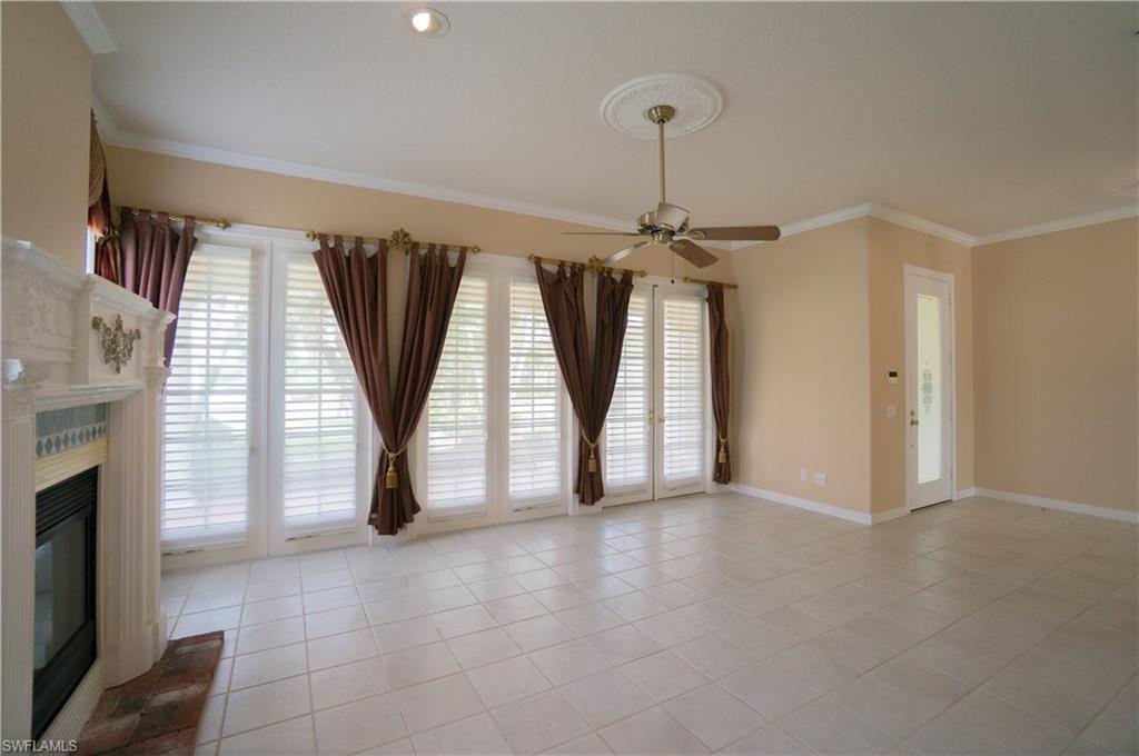 5120 Inagua Way Naples, FL 34119 - Photo 4 of 35 a view of empty room with floor to ceiling window and fireplace