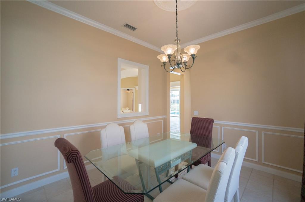 5120 Inagua Way Naples, FL 34119 - Photo 6 of 35 a view of a dining room with furniture and chandelier