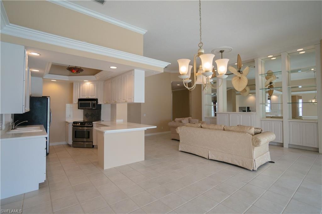 5120 Inagua Way Naples, FL 34119 - Photo 10 of 35 a large white kitchen with a large window and kitchen view