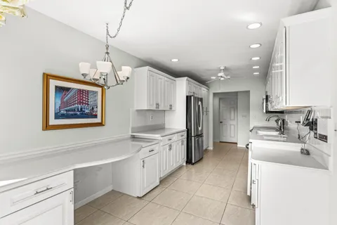 a large kitchen with stainless steel appliances a stove sink and cabinets