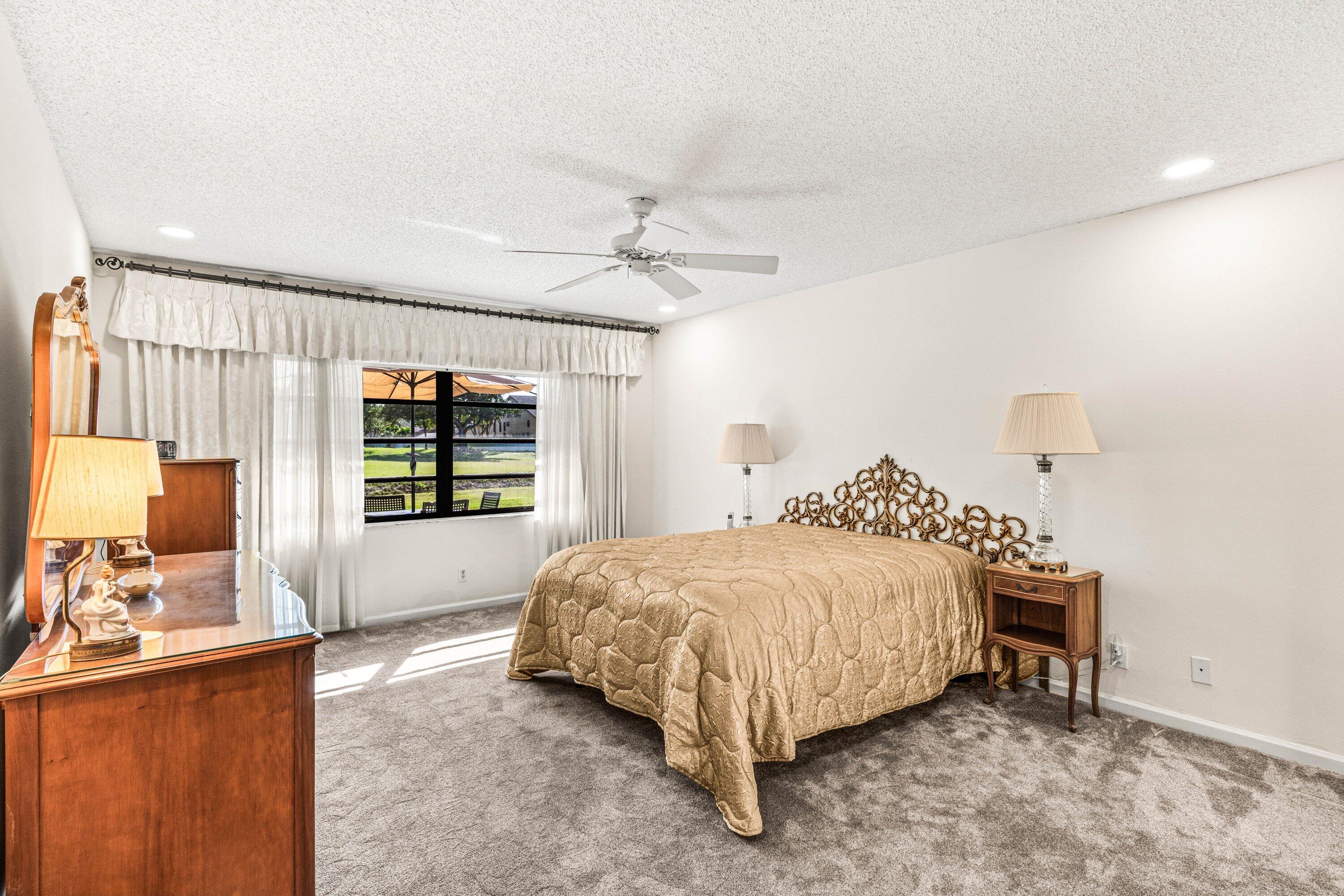 6426 Casabella Lane Boca Raton, FL 33433 - Photo 16 of 42 a bedroom with a bed window and a dresser