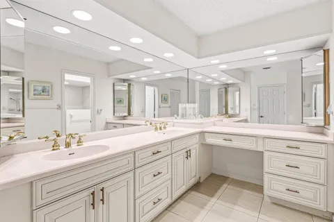 a spacious bathroom with a granite countertop sink mirror and double