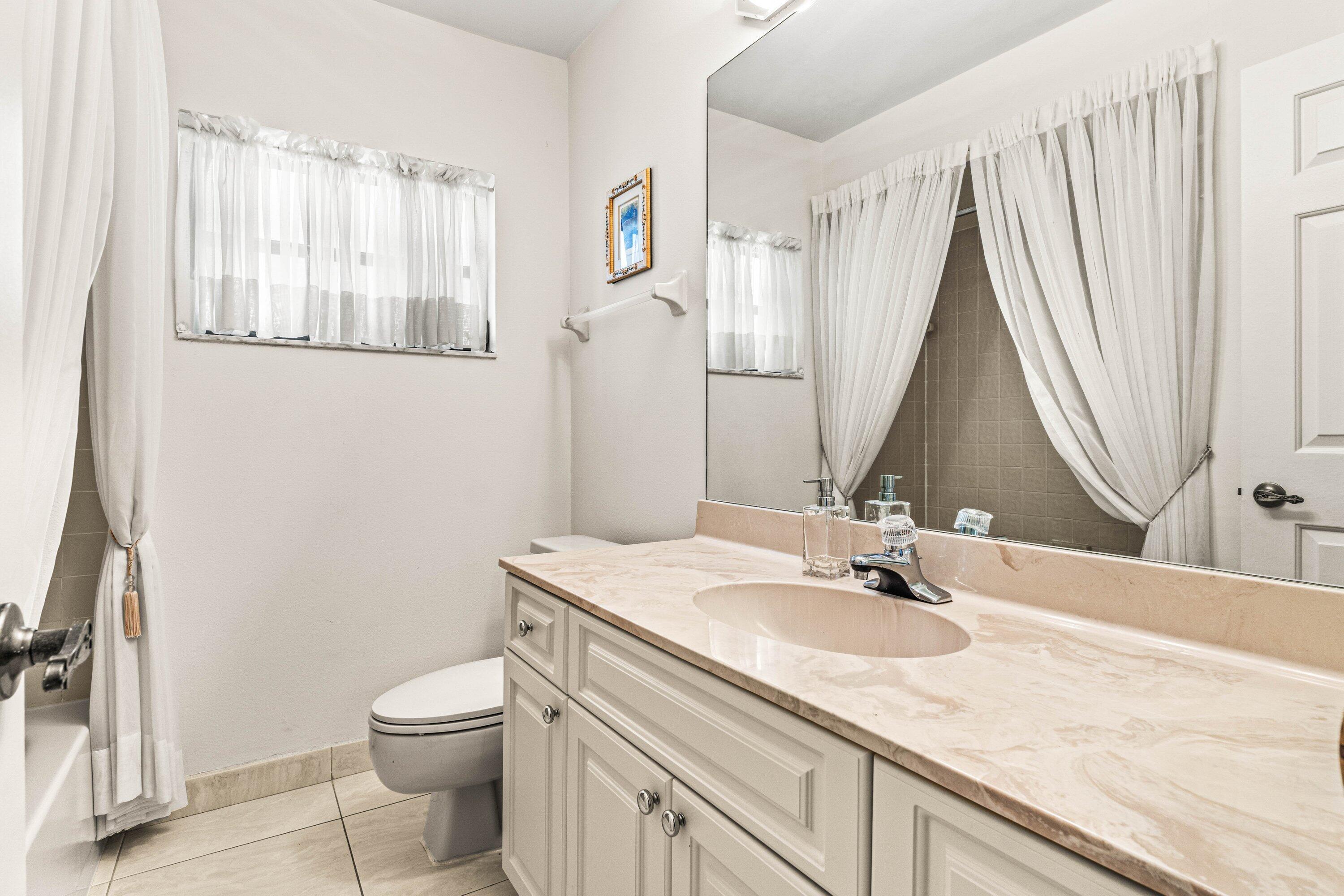 6426 Casabella Lane Boca Raton, FL 33433 - Photo 23 of 42 a bathroom with a granite countertop sink and a mirror