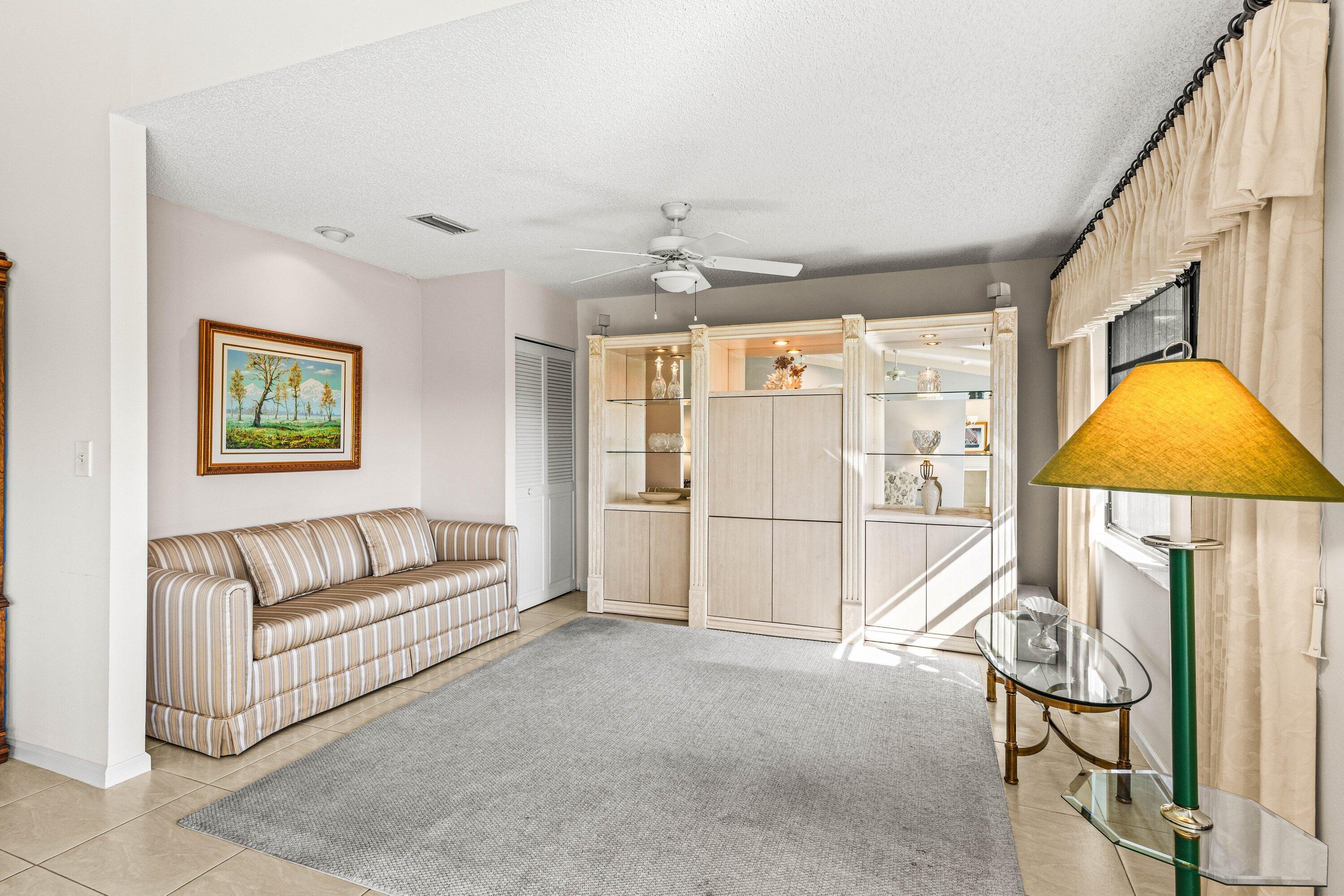 6426 Casabella Lane Boca Raton, FL 33433 - Photo 26 of 42 a living room with furniture a dining table and a chandelier