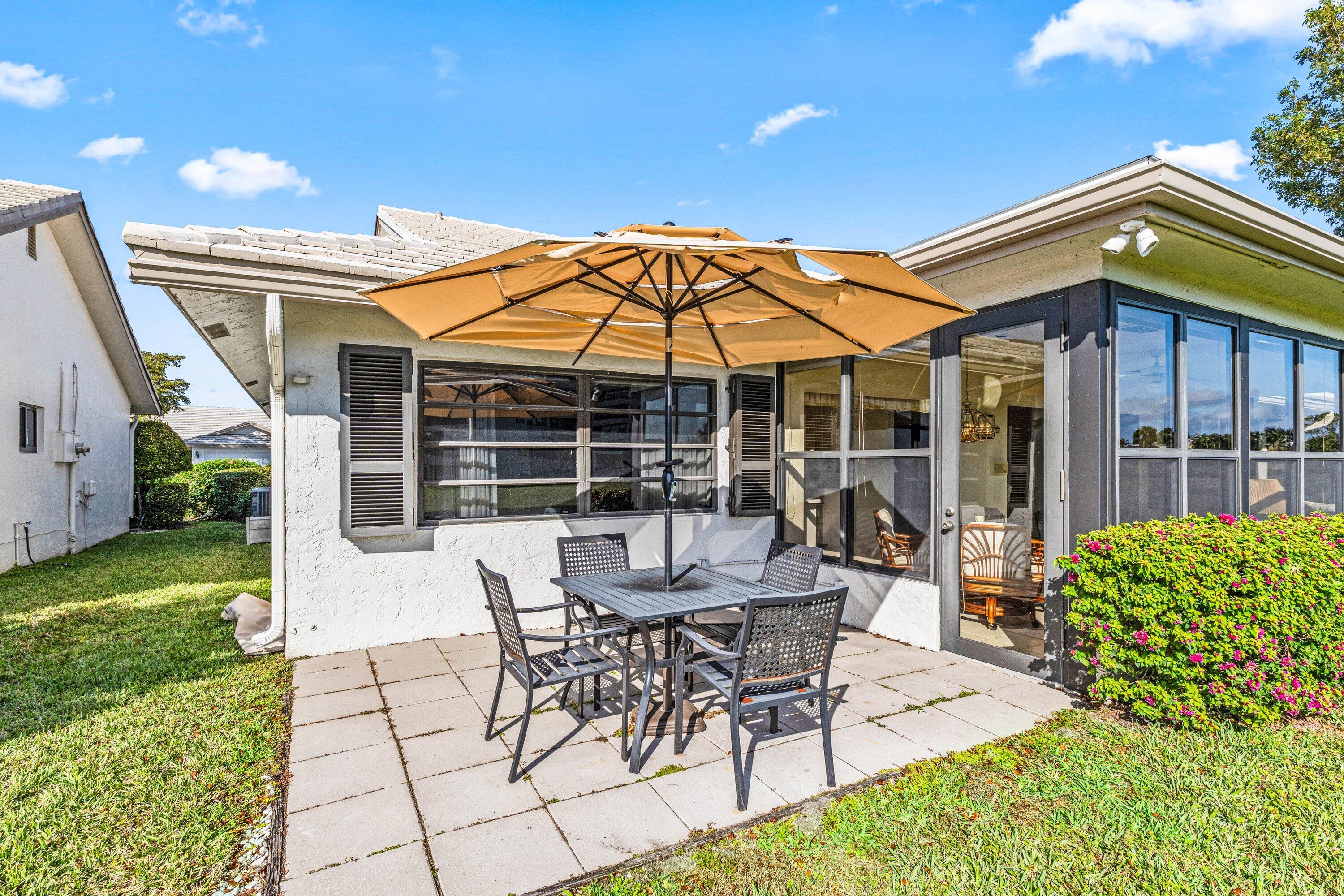 6426 Casabella Lane Boca Raton, FL 33433 - Photo 31 of 42 a view of a house with backyard sitting area and garden