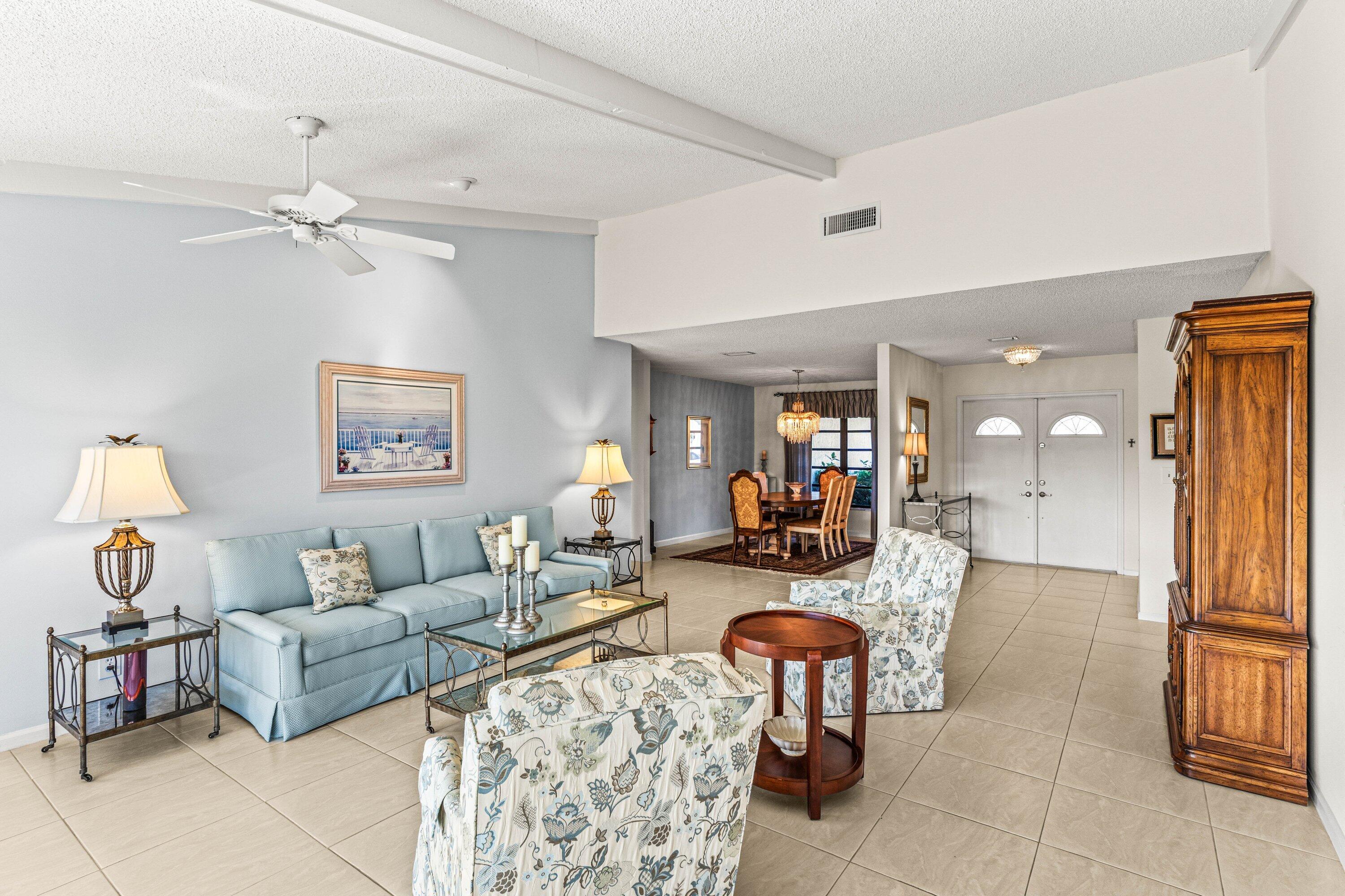 6426 Casabella Lane Boca Raton, FL 33433 - Photo 6 of 42 a living room with furniture and a chandelier