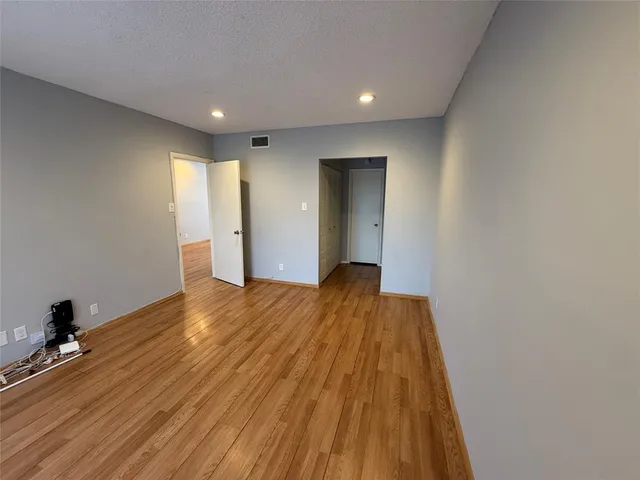 a view of hallway with wooden floor