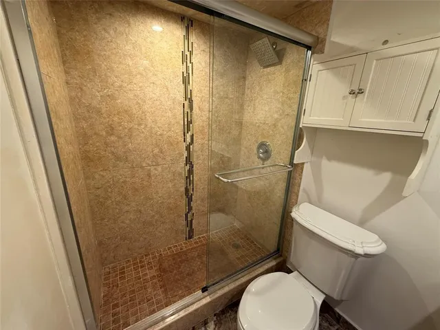 a view of a room with wooden floor and windows