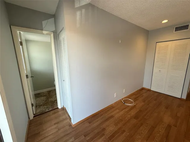a view of hallway with wooden floor